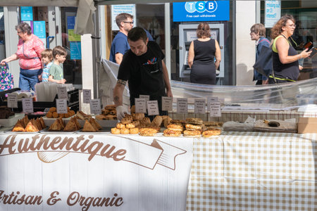 09/02/2019 Winchester, Hampshire, UK A man selling pastry on a market stallのeditorial素材
