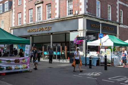 09/02/2019 Winchester, Hampshire, UK the front of marks and spencer shop in Winchester high street Hampshire with shoppers walking pastのeditorial素材