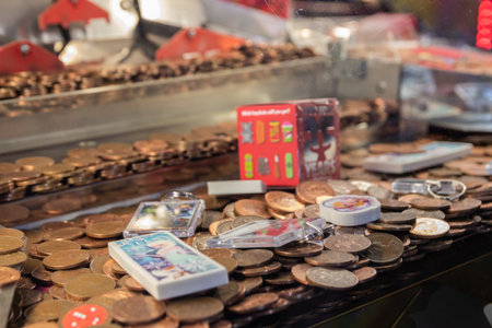 09/14/2019 Portsmouth, Hampshire, UK a close up of the coins on a coin push game at an amusement arcadeのeditorial素材