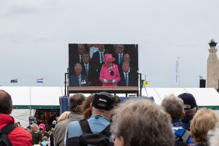 09/14/2019 Portsmouth, Hampshire, UK a crowd watching a big screen as queen Elizabeth addresses themのeditorial素材