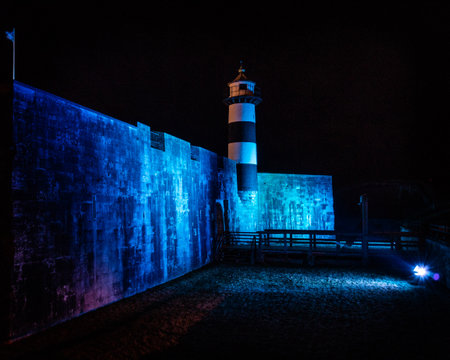 09/14/2019 Portsmouth, Hampshire, UK Southsea castle and lighthouse lit up by blue flood lights at nightのeditorial素材