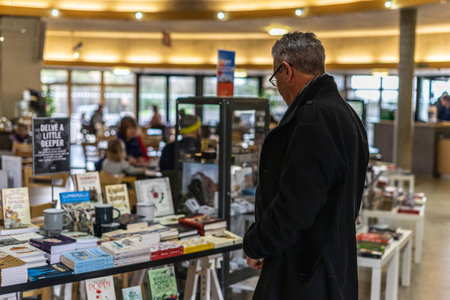 01/11/2020 Portsmouth, Hampshire, UK A middle aged man looking at items in a gift shop of a museumのeditorial素材