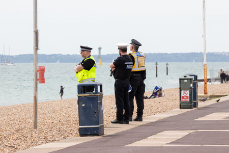 09/14/2019 Portsmouth, Hampshire, UK british police officers on duty in uniform at the seasideのeditorial素材