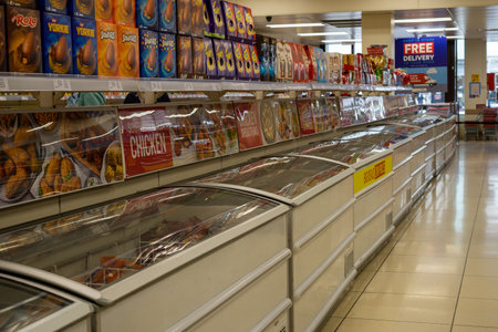 02/05/2020 Chichester, West sussex, UK An empty frozen food Aisle of a supermarket with freezers and products on shelvesのeditorial素材