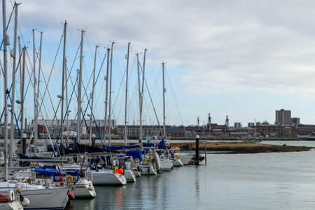 01/29/2020 Gosport, Hampshire, UK Sailing boats docked in Gosport Marina, Hampshire with HMS Victory in the backgroundのeditorial素材