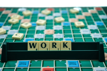 02/09/2020 Portsmouth, Hampshire, UK The word work spelled out on scrabble tiles on a scrabble boardのeditorial素材
