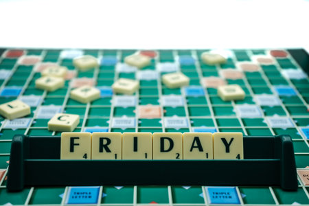 02/09/2020 Portsmouth, Hampshire, UK The word Friday spelled out on scrabble tiles on a scrabble boardのeditorial素材