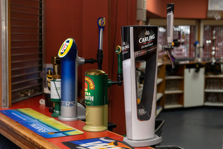 02/21/2020 Portsmouth, Hampshire, UK various brands of beer pump on a bar inside a pubのeditorial素材