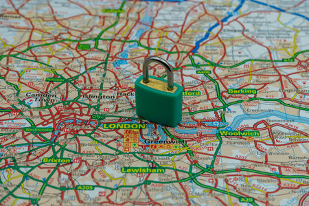 03/14/2020 Portsmouth, Hampshire, UK A locked padlock on top of a road map or geography map of London UKのeditorial素材