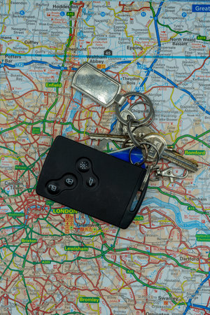 03/14/2020 Portsmouth, Hampshire, UK A set of keys and a car key laid on top of a road map of London