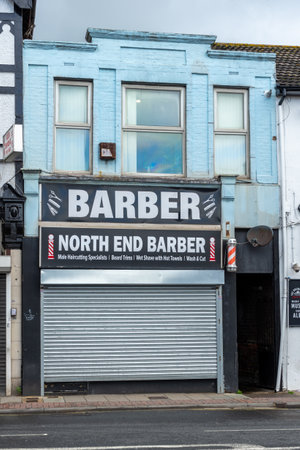 04/30/2020 Portsmouth, Hampshire, UK A closed barber shop on a high street with its shutters downのeditorial素材