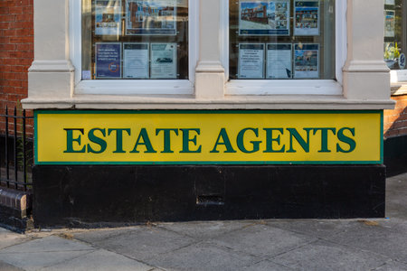 08/02/2020 Portsmouth, Hampshire, UK the front or exterior of an English estate agents with an estate agent sign underneath the windowのeditorial素材