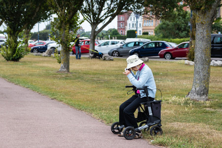 08/04/2019 Portsmouth, hampshire, UK An elderly asian lady taking a test during a walk on a mobility aidのeditorial素材
