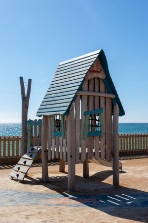 A child's climbing frame and tree house in a playgroundの写真素材