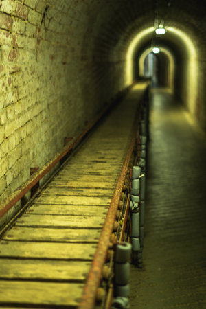 A ammunition conveyer belt leading down a tunnel used in the second world war at Fort Nelson in Portsmouth UKの写真素材
