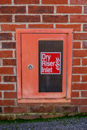 A dry riser inlet cupboard in a brick wallの写真素材