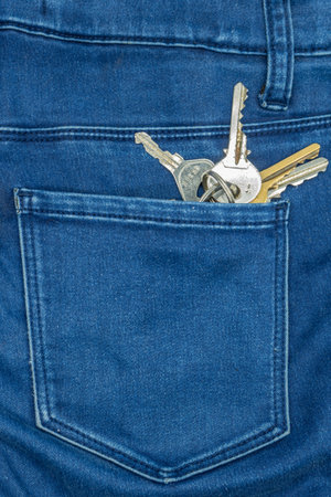 a set of keys in the back pocket of a pair of jeansの写真素材