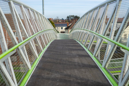 a modern metal bridge crossing a motorwayの写真素材
