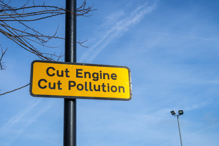 A sign on a lamppost reading cut engine cut pollutionの写真素材
