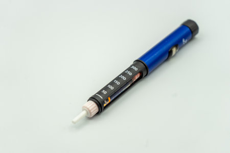 An insulin injection pen used by diabetics with insulin inside isolated on a white backgroundの写真素材