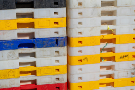 plastic pallets of colours stacked on top of each otherの写真素材