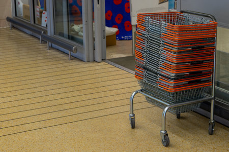 metal Shopping baskets stacked outside a supermarket or storeの写真素材