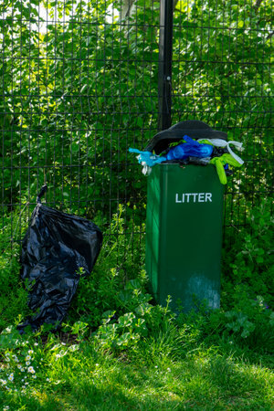 full council litter bins filled with dog poo bagsの写真素材