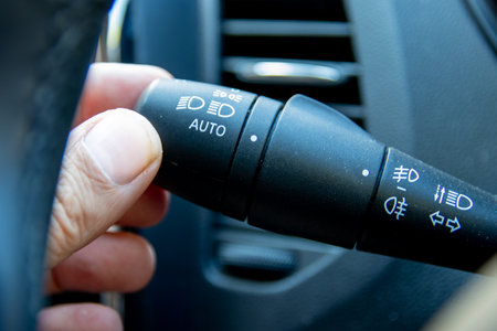 A hand on an indicator stick in the interior of a carの写真素材