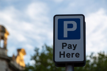a pay here sign in a car parkの写真素材