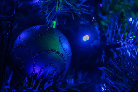 two blue baubles hanging on a christmas treeの写真素材