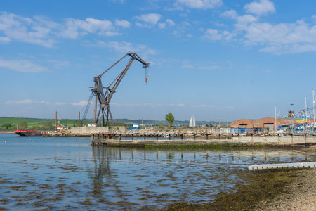 a big industrial metal crane reflecting on water, Tipner, Portsmouth UKの写真素材