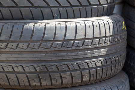 a close up of used car tyres or tires showing the rubber treadの写真素材