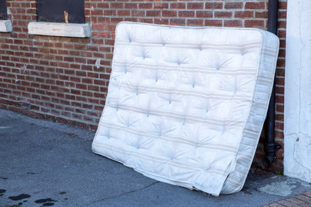 A mattress dumped or fly tipped in the streetの写真素材