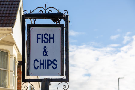 A sign outside a Fish and chips shop or chippy reading Fish and Chipsの写真素材