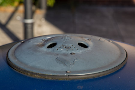 A close up of an ash tray on top of a litter bin in the streetの写真素材