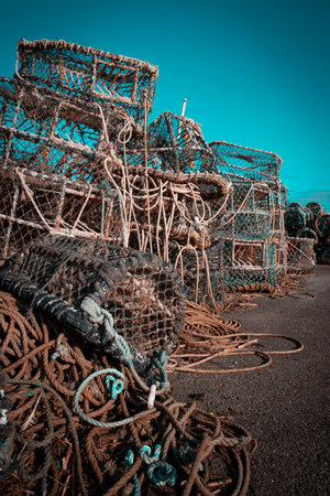 Fishing pots or traps stacked on a dock or quayの写真素材