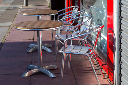 empty tables and chairs outside a restaurantの写真素材