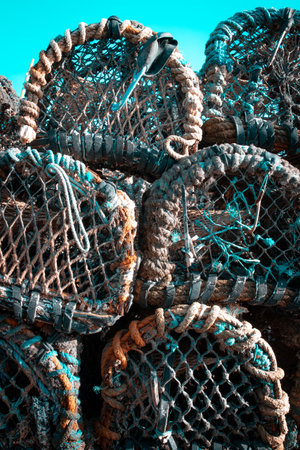 Fishing pots or traps stacked on a dock or quayの写真素材