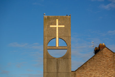 a cross on a a plinth outside a churchの写真素材