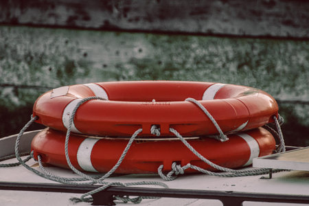 orange life rings stacked on the deck of a boat or yachtの写真素材