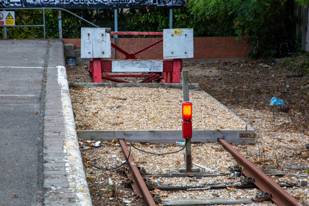 A buffer stop and warning lights at the end of a train trackの写真素材