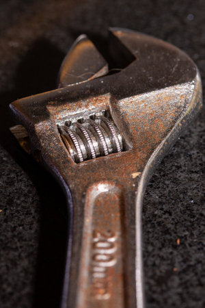 a close up of an old rust adjustable wrench using selective focusの写真素材