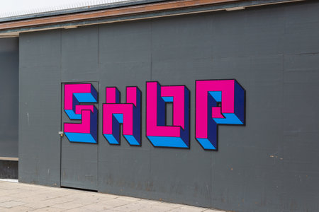 Artwork on the outside of a boarded up shop reading shopの写真素材