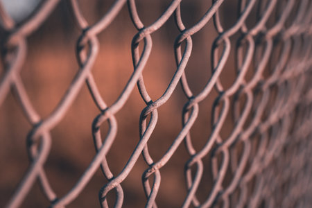 A close up of the links of a chain link fence using selective focusの写真素材