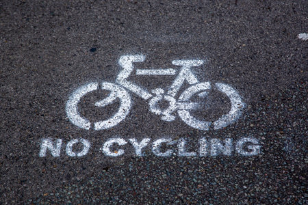 a no cycling sign spray painted on a walkway or sidewalkの写真素材