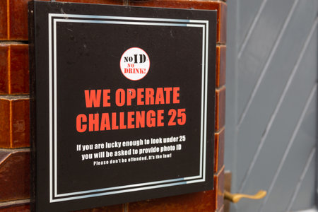 A sign outside a pub showing that they operate a challenge challenge 25 policy for customer when asking for identification to verify their ageの写真素材