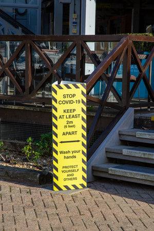 a sign showing the rules on social distancing outside a restaurantの写真素材