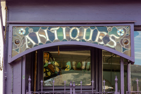 The sign above an antiques shop reading Antiquesの写真素材