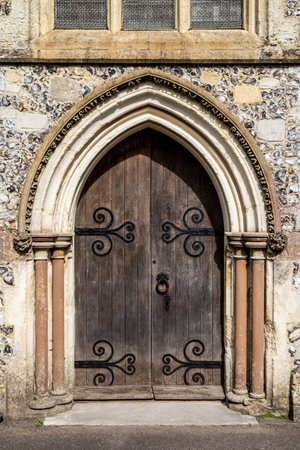 Old wooden doors at the entrance to an old english churchの写真素材