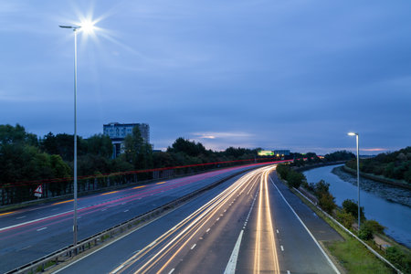 Light trails of cars speeding on a British Motorway before dawnの写真素材
